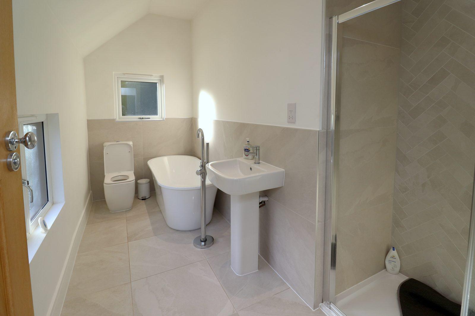 Bathroom before: new white suite with nothing on the walls