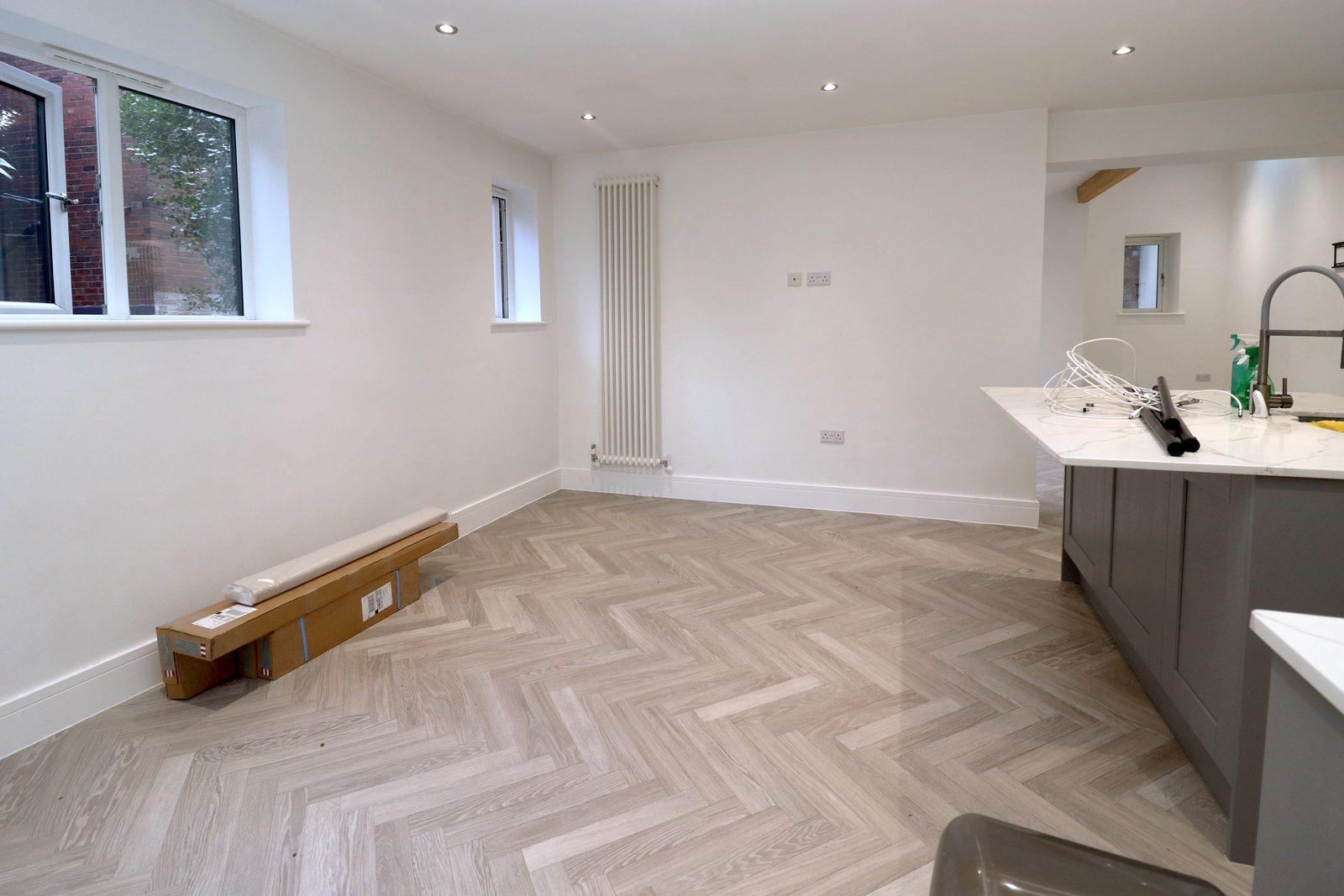 Dining area before: empty corner with a tall radiator and window