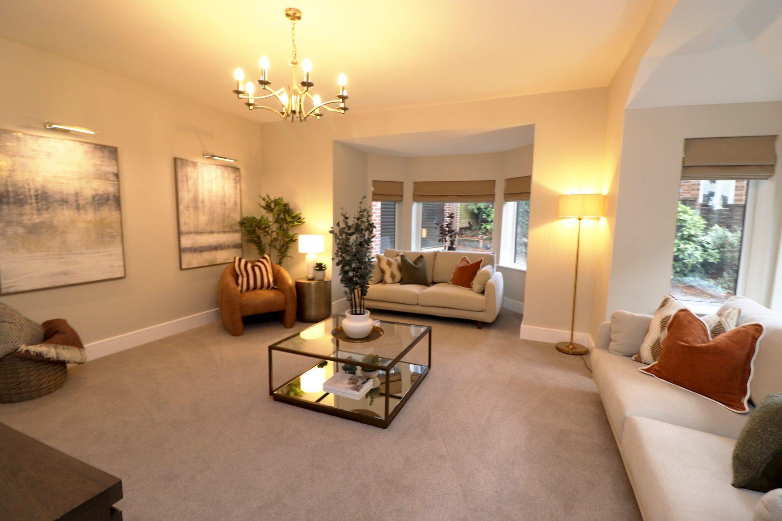 Two canvases, floor lamp and the sofas in the bay