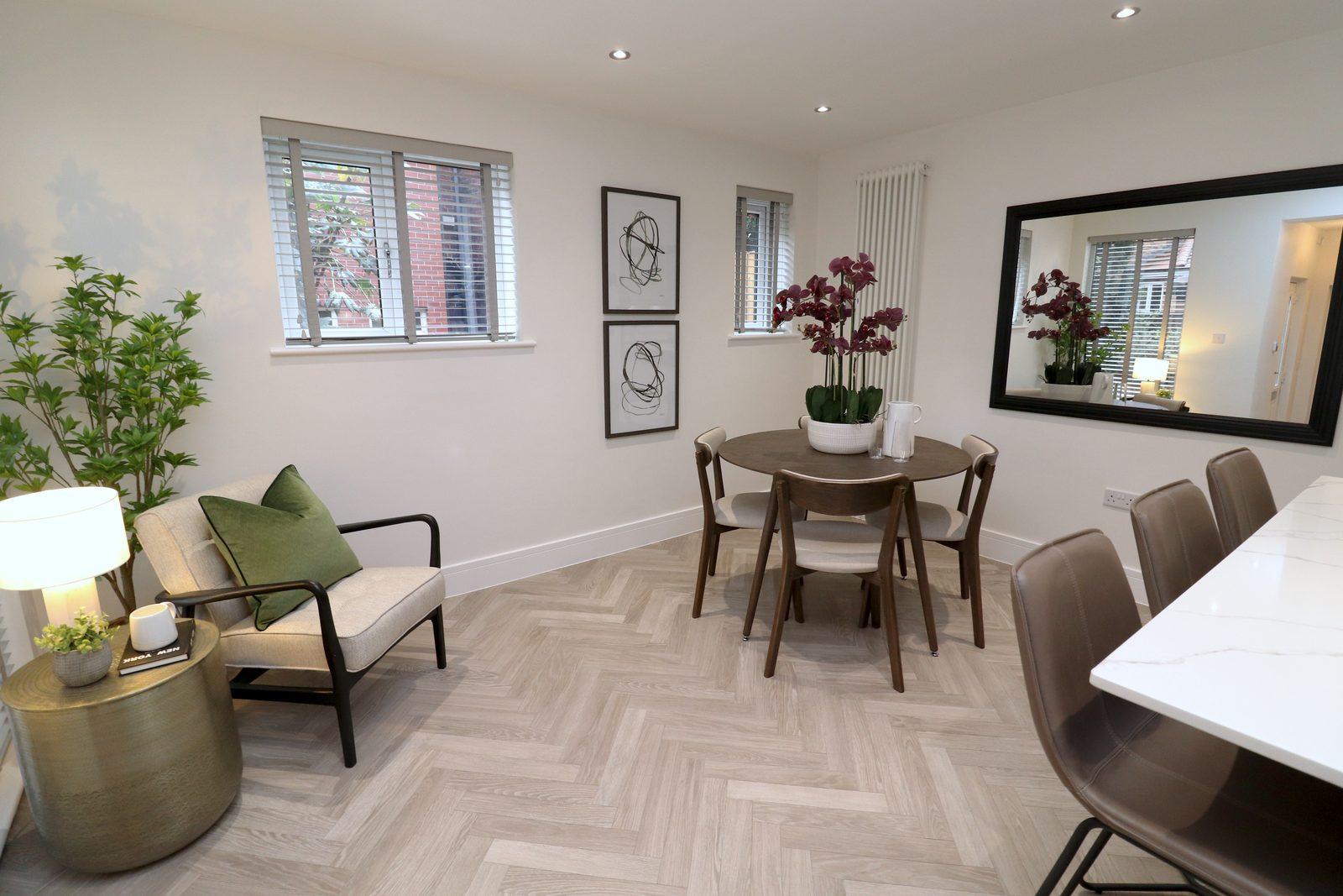 Dining table, chairs and mirror beside the kitchen