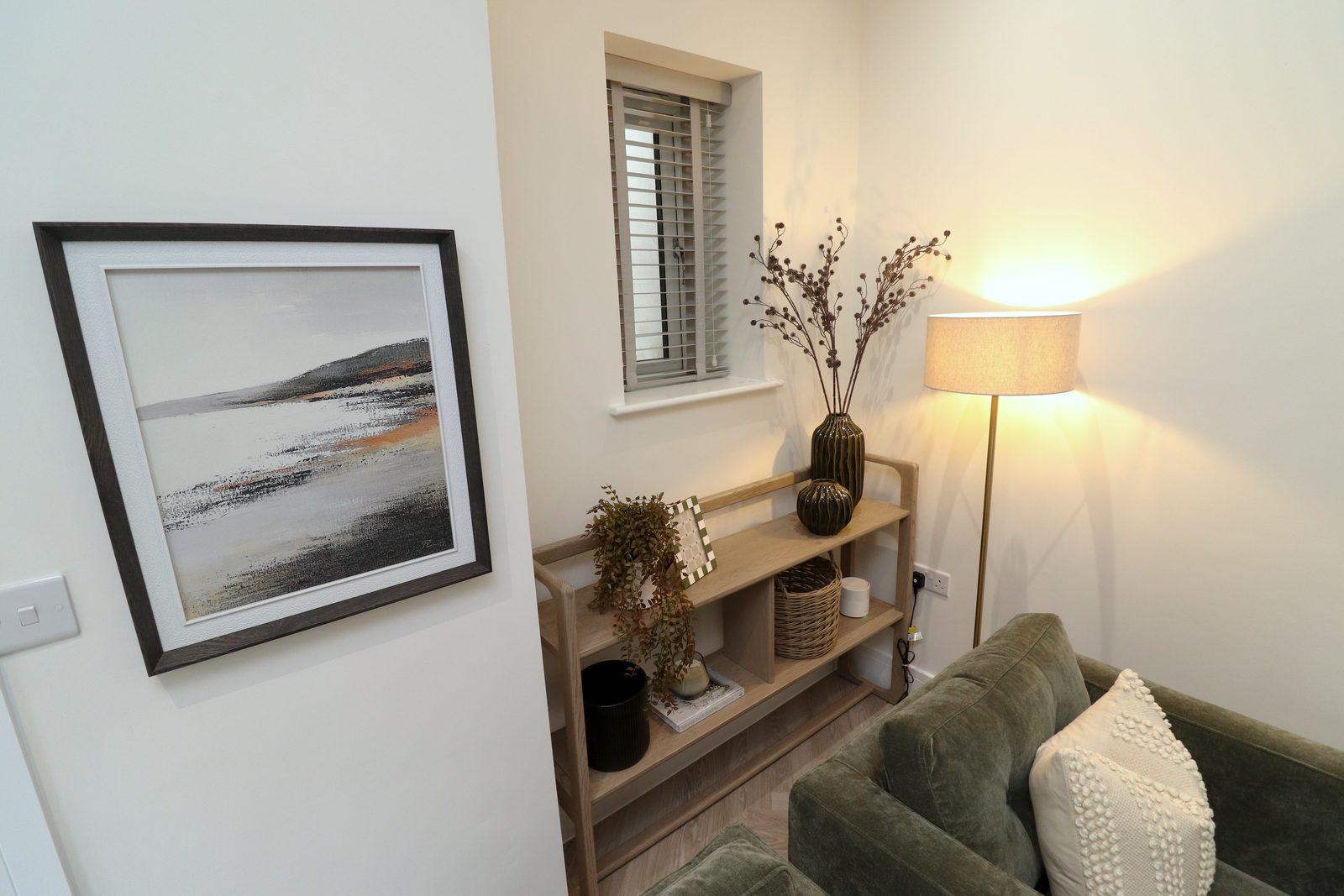 Framed seascape, console, floor lamp and armchair