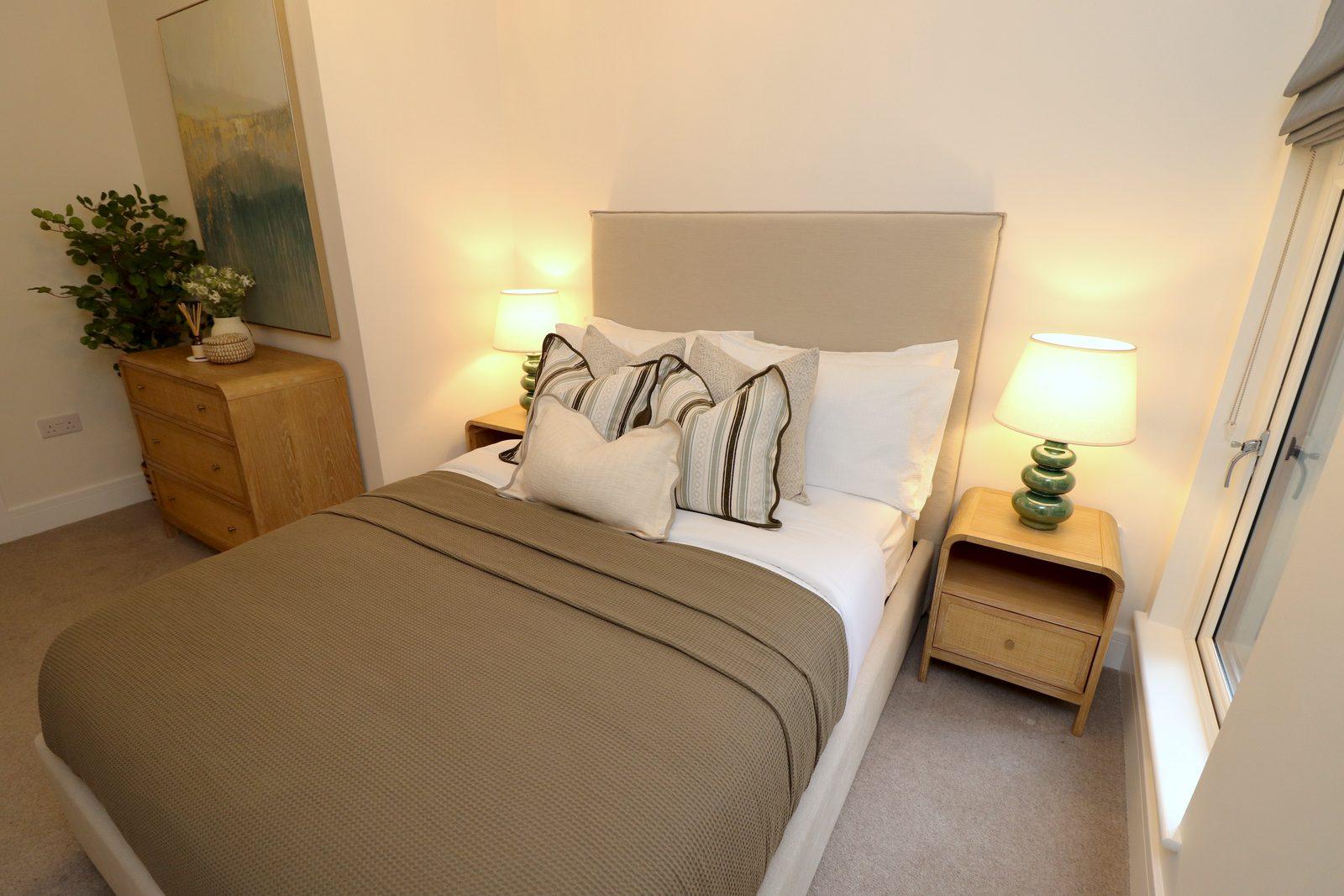 Dressed bed, lamp and canvas