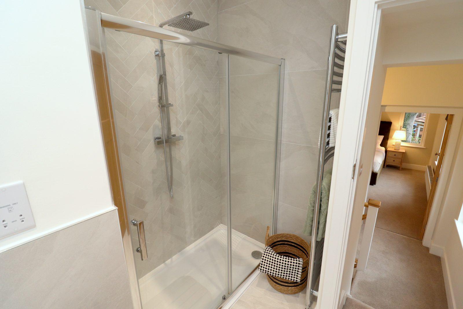 Walk-in shower with wooden stool