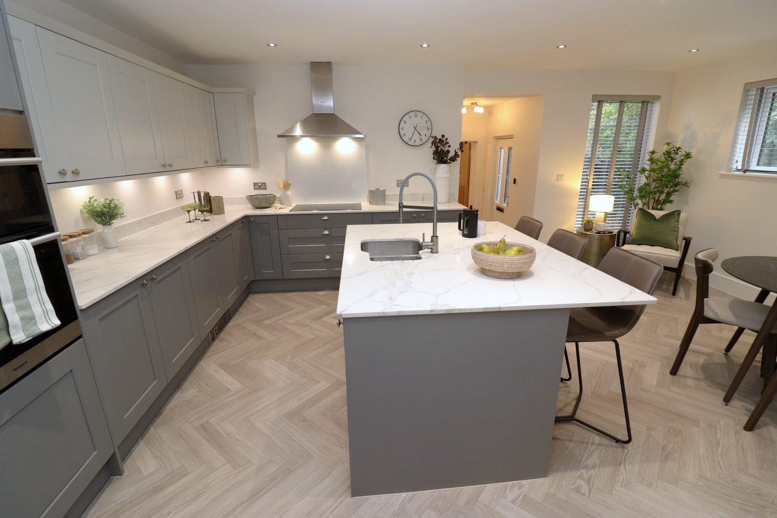 Kitchen after: island dressed with a tray and fruit, dining table visible beyond