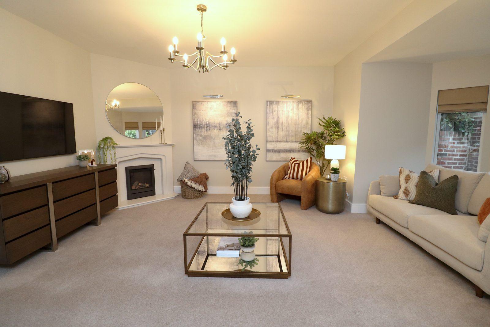 Living room after: television unit, round mirror over the fireplace, two large canvases