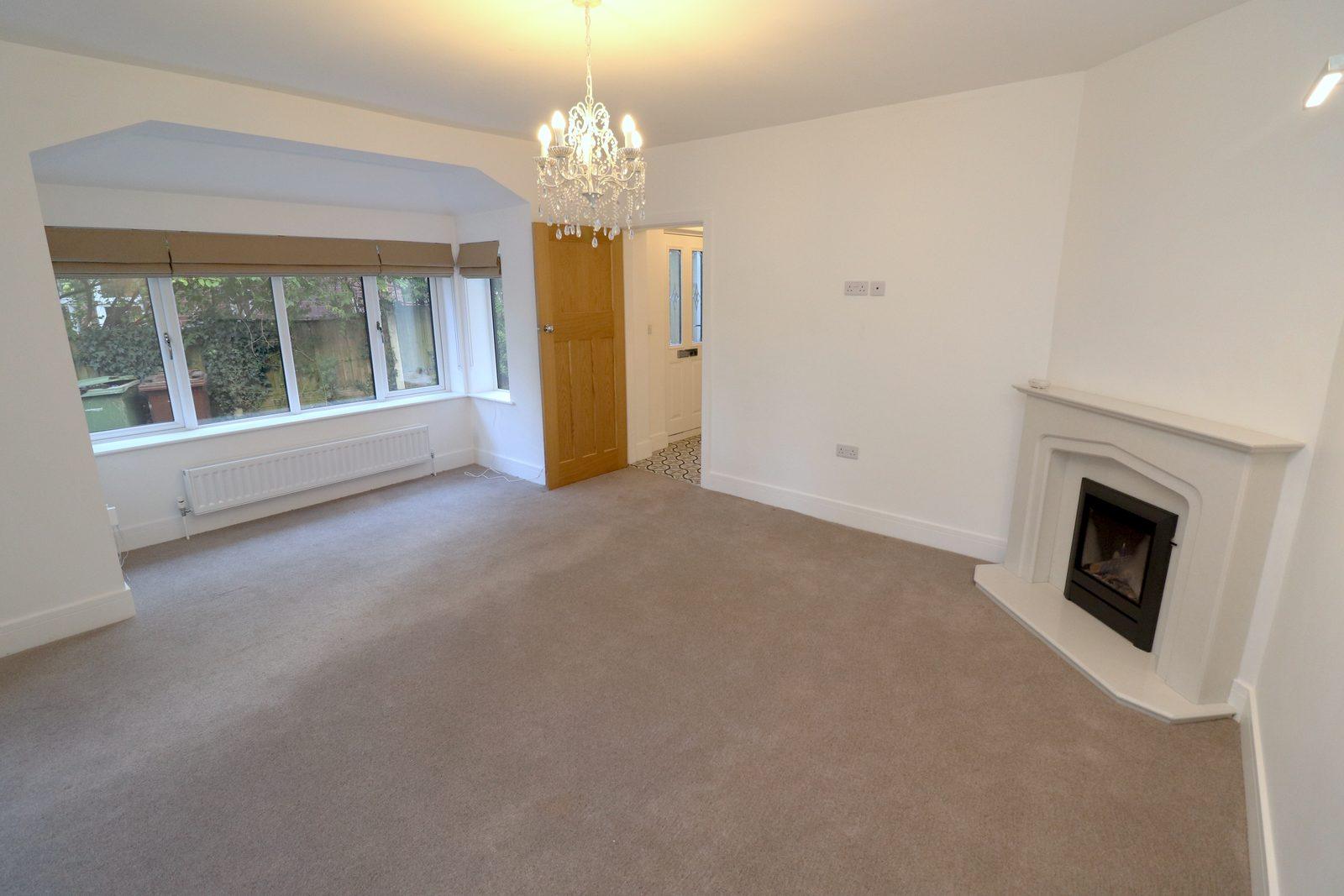 Living room before: view from the window end towards the door and fireplace
