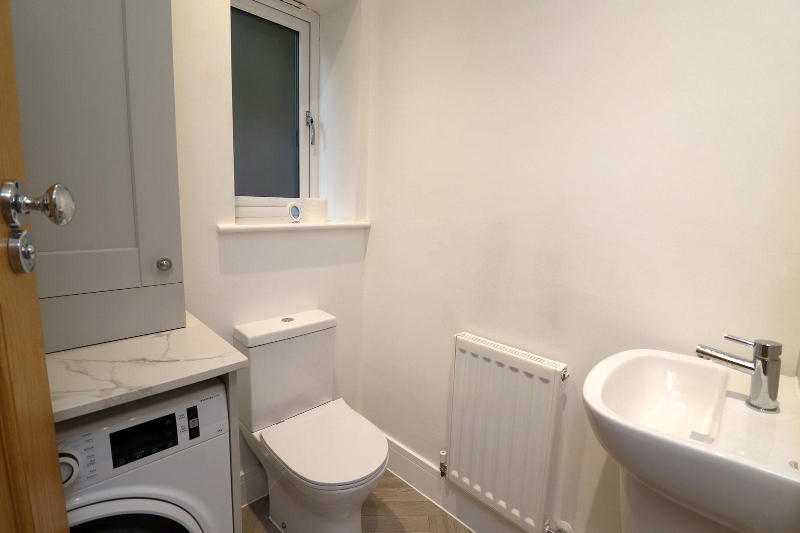 Utility room before: washing machine, toilet and basin